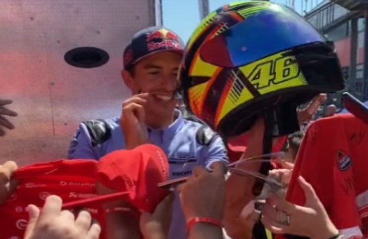 Marc Marquez firma il casco di Valentino Rossi ad un fan